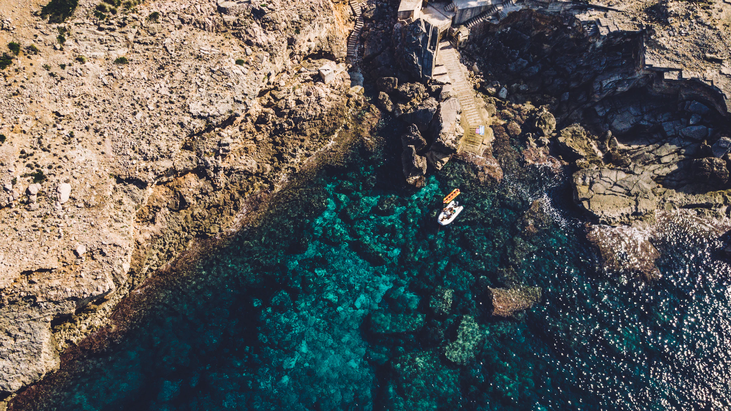Sunlit rocks and clear water at Cala Sant Vicenç, Mallorca